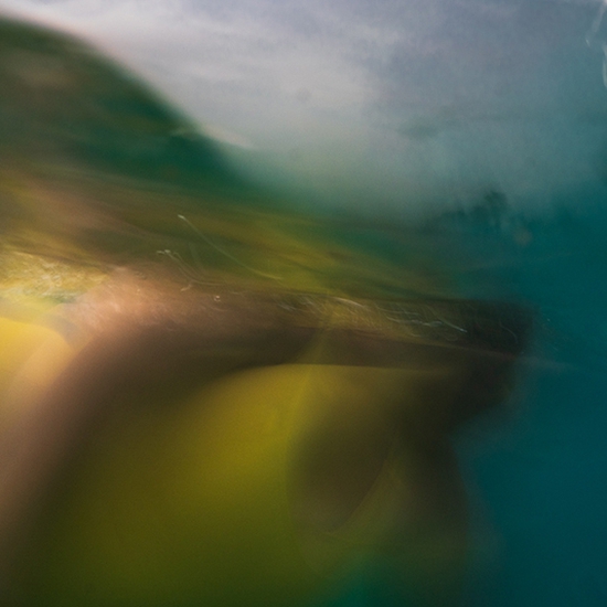 Deb Achak: Krista Floating in the Waves, Maui, 2020, Digital archival pigment print, 15 x 34, 20 x 45, 30 x 68 inches