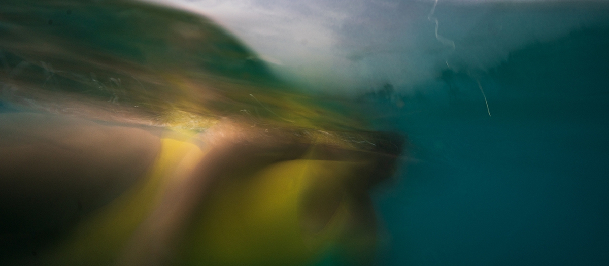 Deb Achak: Krista Floating in the Waves, Maui, 2020, Digital archival pigment print, 15 x 34, 20 x 45, 30 x 68 inches