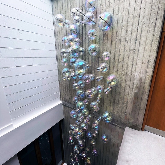 Alva Gallagher: Ascend, 2024, Iridescent Blown Glass and Stainless Steel, 472 x 79 inches