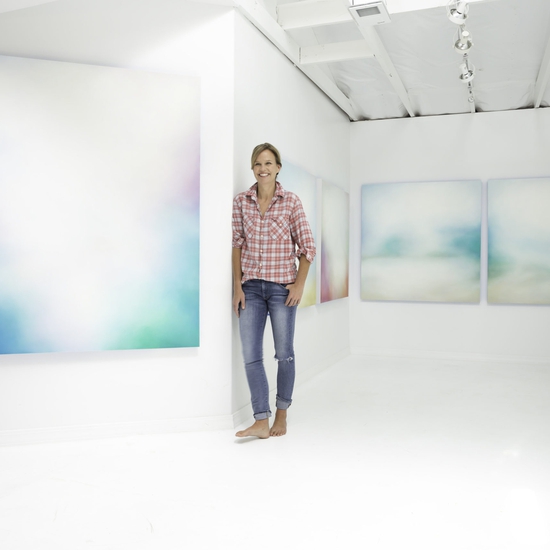 Tracy Rocca with her paintings