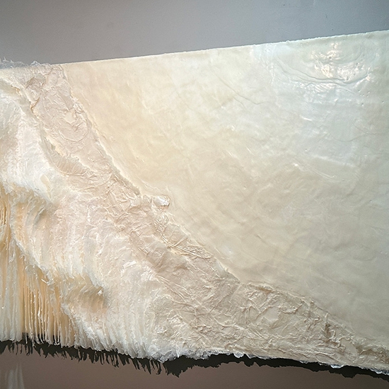 Kandis Susol, Radical Compassion, 2023, Artist made paper encaustic sculpture, 38 x 73 x 5 inches