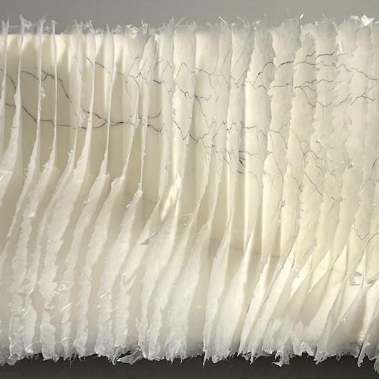 Kandis Susol: Reaching Out, 2023, Artist made paper encaustic sculpture and Sumi ink, 15 x 25 x 5 inches